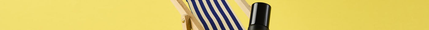 Oud rollerball on a miniature striped deckchair