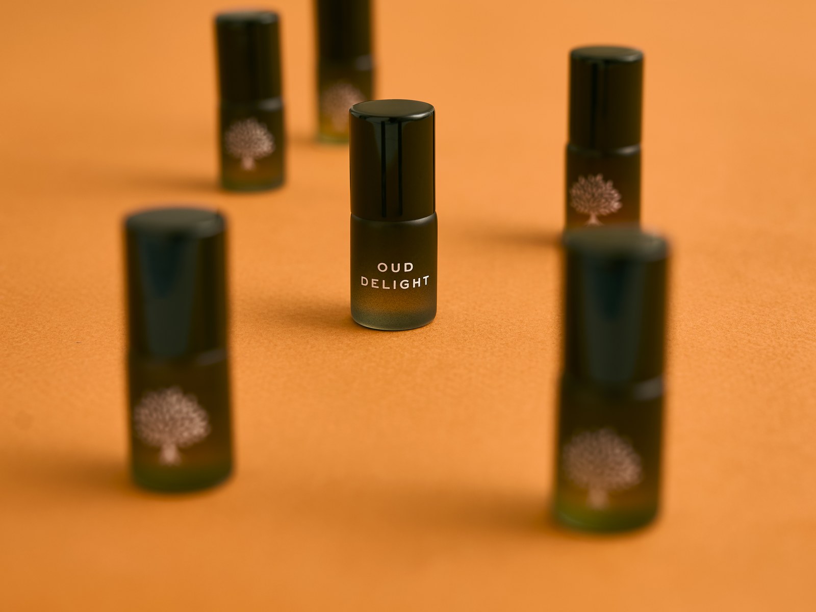Five Discovery Collection oud rollerballs on orange
