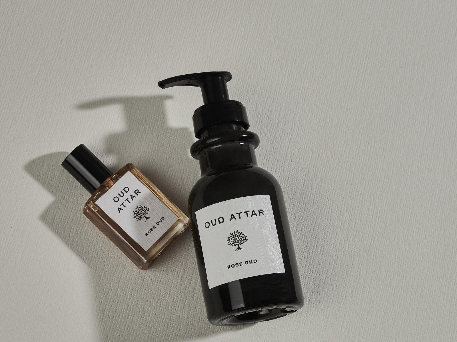 Oud Attar body lotion with a small elixir bottle